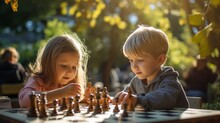 Two Kids Playing A Game Of Chess In The Park 