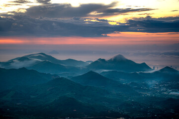 Wall Mural - Watching the sunrise on the high mountains, far away is the famous coastal tourist city of Nha Trang