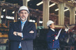 © amorn - Senior male business manager working and inspecting of project in the industry factory