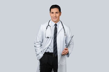 Wall Mural - Professional doctor in medical coat over light wall background