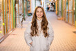 © be free - happy teen curly girl wearing hat. photo of teen curly girl outside. teen curly girl in the street