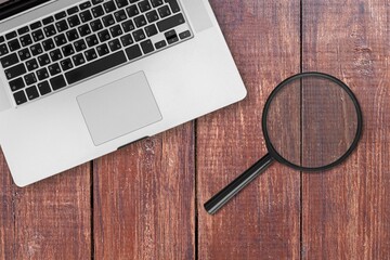 Poster - the magnifying glass and computer keyboard on desk