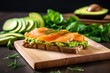 sandwich with avocado and smoked salmon on a board