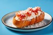 lobster roll on a seashell-shaped plate against blue background