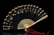 a single oriental hand fan opened on a black velvet surface