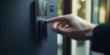 Close-Up of a Finger Pressing a Fingerprint Sensor Next to a Doorknob for Keyless Access to a Front Door