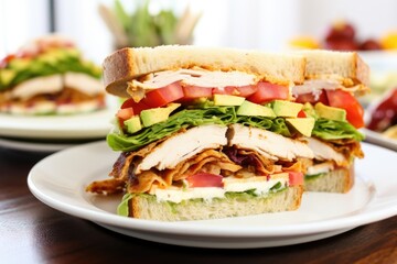 Canvas Print - cross-section of a chicken club sandwich on a white plate