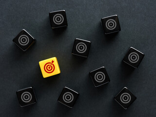 Poster - Goal setting and selecting the most suitable goal for business purposes. Target goal symbols on black cubes.