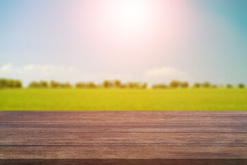 Poster - Wooden table on blur field background