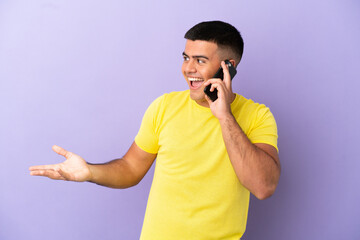 Wall Mural - Young handsome man using mobile phone over isolated purple background with surprise expression while looking side