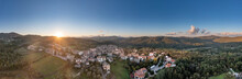 Italy, Tuscany, Torniella, Aerial Panorama Of Mountain Village At Sunset