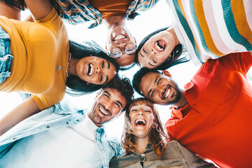 Wall Mural - Multicultural community of young people smiling at camera outside - International university students taking selfie picture together - Friendship concept with guys and girls having fun on city street