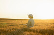© Westend61 - Agronomist holding laptop amidst crops in wheat field