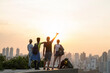 © Westend61 - Friends enjoying sunset view from rooftop