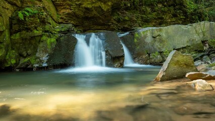 Wall Mural - Time lapse video of Maiden's Tears waterfall in Carpathian mountains. Beautiful footage of water falling from rocks in mountains