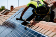 © Westend61 - Engineer with hand tool installing solar panel on sunny day