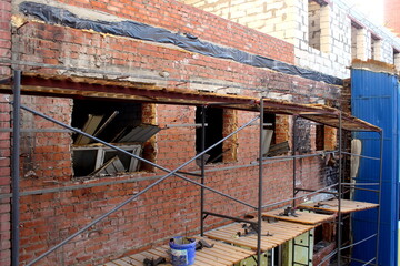 Building renovation. There are leis near the front of the house.