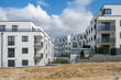 © Westend61 - Germany, Bavaria, Odelzhausen, Modern suburban buildings with construction site in foreground
