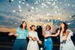 © Westend61 - Cheerful friends celebrating together and having fun with confetti at sunset