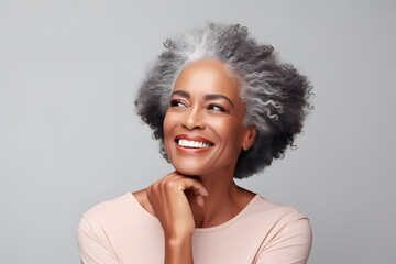 Canvas Print - Smiling black adult woman touch face with smooth healthy skin. Open healthy smiling beautiful aging mature woman with white teeth. Beauty, dental and cosmetics skincare advertising concept.