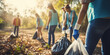 A team of young and diverse volunteers remove trash to clean up the environment