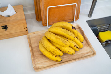 A bunch of fresh banana in a modern kitchen.