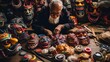 Bird's eye view of an old Asian man sitting bent over and drawing on a mask. Surrounded by several colorful Chinese masks.