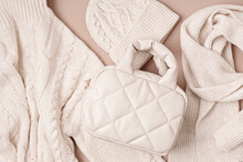Beige Quilted Puffed Bag And Woolen Accessories On Pastel Background. Stylish Woman Outerwear. Winter Fashion Accessories