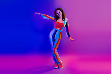 Wall Mural - Full size portrait of gorgeous cheerful girl have good mood dancing chilling isolated on vibrant colorful neon background