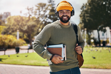 Student, headphones and backpack on campus of education, college or university podcast in park. Portrait of african man walking, travel and books with audio, electronics or listening to music outdoor