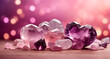 Amethyst and Rose Quartz stones on pink bokeh background. Love and healing stones. 