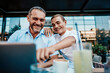 © Dusko - Handsome and happy father and his teenager son sitting in a restaurant and talking.