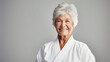 Portrait of happy senior woman at karate course