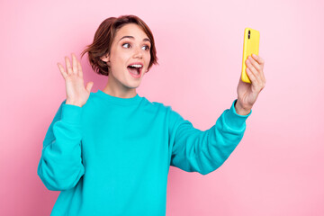 Poster - Photo portrait of pretty young girl arms wave arm video call make selfie wear trendy blue outfit isolated on pink color background