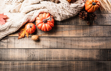 Wall Mural - autumn and thanksgiving decoration concept made from autumn leaves and pumpkin on dark wooden backgr