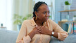 © Charlize Davids/peopleimages.com - Black woman, chest pain and heart with health issue at home, emergency and breathing fail with indigestion. Respiratory, pneumonia or tuberculosis, lungs or cardiovascular healthcare or anxiety