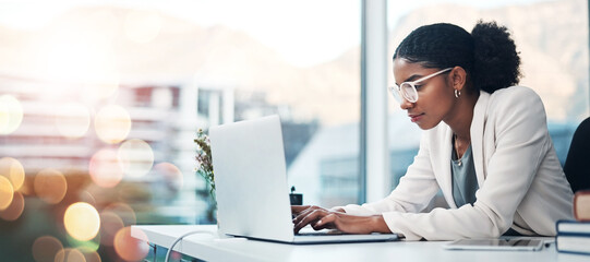 Poster - Businesswoman, laptop and typing a proposal in corporate office, agenda and report or schedule. African person, research and review or email via internet, digital and technology with bokeh in mockup