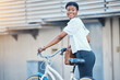 Black woman, bicycle commute and business on road in city with sustainability travel, ride and morning with smile. Happy worker, female professional and employee with bike for carbon footprint