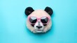 Panda head with pink sunglasses on a blue background.