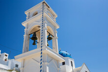 Santorini Landmark Orthodox Christian Church With Bell Tower And Blue Dome On A Summer Sunny Sky