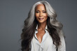 © Tetiana - Generative AI image of a stunning attractive mature woman with beautiful long wavy hair isolated on grey background