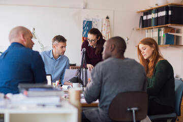 Group of people working together on a project in a startup company office