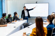 © narong - Business manager man point to monitor and explain about the progress of the project to his employee in conference or meeting room.