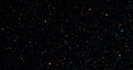 Wall Mural - Cinematic warm dust glitter particles floating on black background in slow motion. Atmosphere overlay. Filmed with RED camera. High quality 4k footage