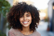 © deagreez - Generative AI picture of beautiful young woman afro volume hair style in the street sunny day