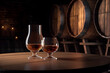 © tynza - Glasses of cognac on the table in the cellar of traditional winery.