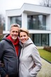 © piai - A 40 year old couple is having fun in front of their modern house. Generative AI