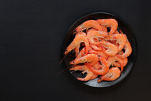 Boiled Shrimp In A Black Plate On A Dark Background. Fresh Shrimp On A Gray Background, Top View. Seafood. Healthy Eating Concept. Template For Menu
