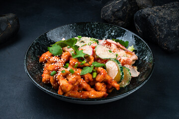 Wall Mural - Fried chicken fillet in honey sauce and fresh vegetable salad with cucumber, radish, tomato.