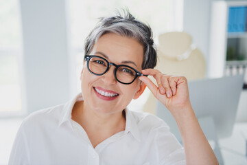 Poster - Photo of happy confident lady specialist wear white shirt hand arms eyeglasses smiling indoors workplace workstation